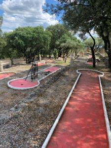 a red carpet in a park with a playground at Camping l'Horizon 30 in Les Mages +1 photo