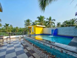 a pool with a water slide in a resort at Villa platinum 4 BHK Calangute in Calangute