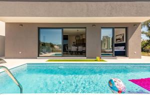 a swimming pool in front of a house at Stunning Home In Zaton in Zaton +27 photos