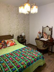 a bedroom with a bed and a table with a bedspread at Casa Rural Abuela Carolina in Bermillo de Sayago