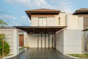 a house with a roof over a driveway at Amanara Villa by Premier Hospiality Asia in Tanah Lot