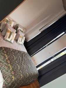 a small bedroom with a bed and a window at Penthouse in Nowy Sącz