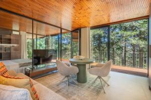 a living room with a table and chairs and a fireplace at Villas Prendal Eco Living - Minho's Guest in Guimarães