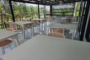 a row of tables and chairs in a restaurant at Resort Thalang in Phuket