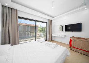 a bedroom with a large bed and a large window at Villa Poyraz in Kas +34 photos