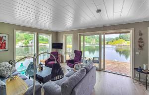 a living room with a couch and a table at Amazing Home In Bremnes With Wifi in Bremnes