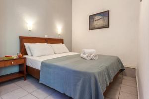 A bed or beds in a room at Argo Pension