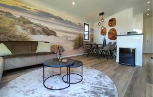 a living room with a couch and a table at Beautiful Home In Voorthuizen in Voorthuizen