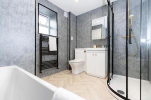 a bathroom with a shower and a toilet and a sink at Bob Hannah Cottage in Cockfield +43 photos