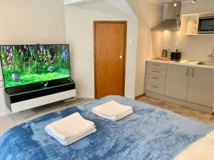 a kitchen with a fish tank on a tv at Castor Bay Coastal Escape Walk to Beach in Auckland