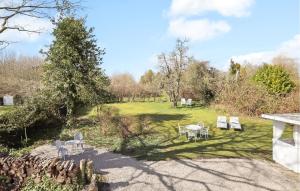 a garden with tables and chairs in a field at Awesome Home In Humble With Wifi in Humble +30 photos