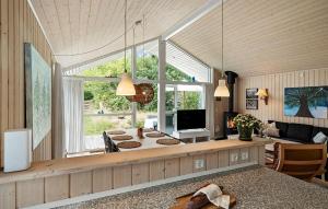 a living room with a table and a large window at 3 Bedroom Stunning Home In Kalundborg in Kalundborg