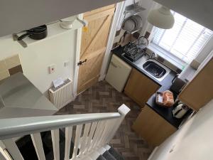 an overhead view of a small kitchen with a staircase at Mulberry cottage 4 Spring Bottom in Walsden