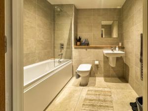 a bathroom with a toilet and a sink at Flat in Greater manchester in Manchester