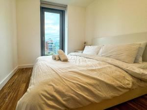 a bedroom with a large bed with a large window at Flat in Greater manchester in Manchester