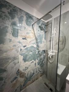 a shower with a mural of clouds on the wall at Apartel Elia 2 in Mamaia Nord