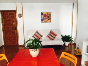 a living room with a table and a couch at Axarquia Apartments in Nerja