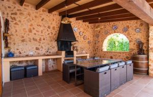 a kitchen with an island and a stove in a room at Can Sanchez in Campos