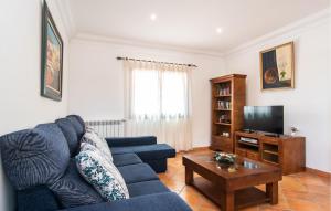 a living room with a blue couch and a tv at Can Sanchez in Campos
