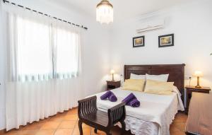 a bedroom with a bed with purple pillows on it at Can Sanchez in Campos +32 photos