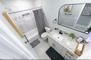 a bathroom with a sink and a toilet and a mirror at Bloomsbury Dr in Kissimmee