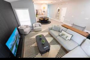 a living room with a couch and a flat screen tv at Bloomsbury Dr in Kissimmee