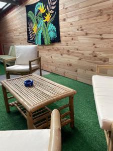 a room with two chairs and a table and a bench at Villa De la mer au volcan in Saint-Pierre