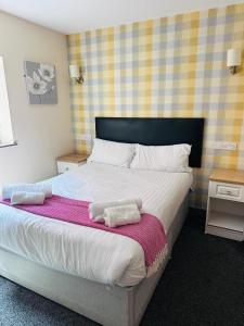 a bedroom with a bed with two towels on it at The Station Inn in Birmingham
