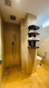 a bathroom with a shower stall and a toilet at Royal Tiger Luxury Resort in Sauraha