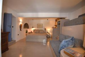 a bedroom with a bed and a couch at Vivian Suites Katoi in Triandáros