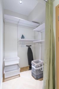 a walk in closet with white shelving and stairs at Jkia luxury Apartments in Nairobi