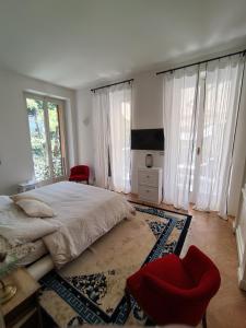 a bedroom with a large bed and a red chair at Il Mulino di Valeria in Canzo +22 photos