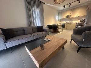 a living room with a couch and a coffee table at Perlia Cozy Apartment in Poros