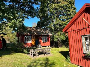 a red house next to a red shed at Lommen in Dals Långed
