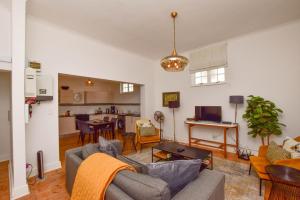 a living room with a couch and a table at Dalebrook Place Kalk Bay near Tidal Pool in Kalk Bay