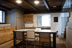 a kitchen with a table and chairs and a sink at BnB 1504 in Oulx