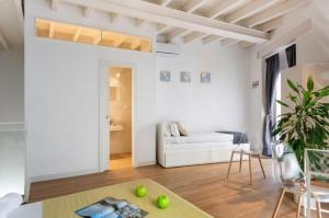 a white living room with a couch and a table at Bajo Gerona in Seville