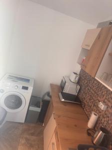 a kitchen with a washer and a washing machine at Locuință privată la mare in Schitul +8 photos