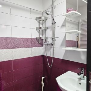 a bathroom with a shower and a sink at Apartament Zarnesti free parking VMP 2 in Zărneşti +17 photos
