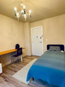 a bedroom with a bed and a desk and a table at La Casa De Los Gatetes in Dúrcal +31 photos