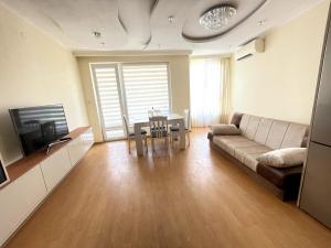 a living room with a couch and a table at 2BR Garden Bay Apartment in Varna City