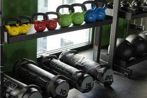 a gym with weights and dumbbells on a shelf at The Social Hub Rotterdam in Rotterdam