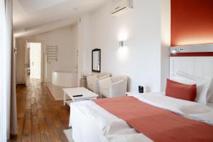 a bedroom with a bed and a bathroom with a tub at Rudolfo Hotel in Lviv