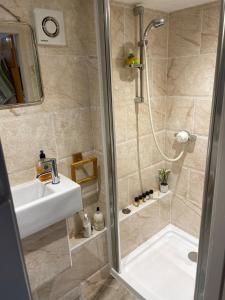 a bathroom with a shower and a sink at Private Luxury Open-Plan Barn Conversion in Sale