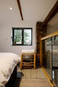 a bedroom with a bed and a window at Private Luxury Open-Plan Barn Conversion in Sale