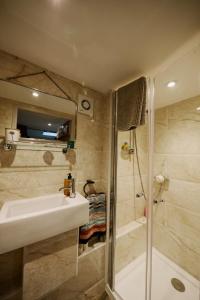 a bathroom with a sink and a shower at Private Luxury Open-Plan Barn Conversion in Sale +32 photos