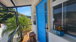 a blue door on a balcony with a bike at ensueños in Búzios