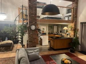 a kitchen and a living room with a loft at Private Luxury Open-Plan Barn Conversion in Sale