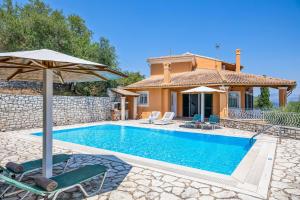a villa with a swimming pool and a house at Villa Milka in Kalami