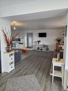 a large living room with a couch and a table at Schwarzwald Lodge EG - Perfekt für Familien in Calw